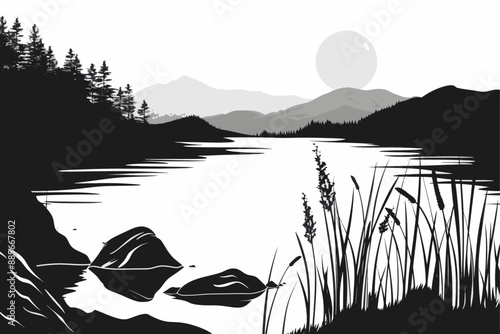 Lake with reeds and mountains at sunrise