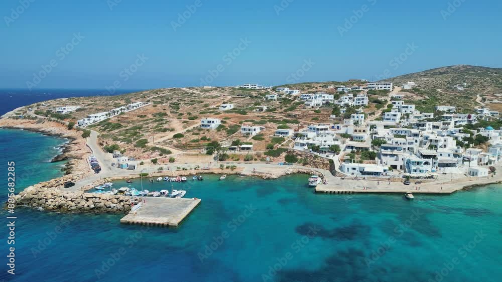 Aerial view of Donousa Island, Greece. Small harbor with boats amidst whitewashed buildings and scenic coastline. Turquoise waters surround the island Aerial view of Donousa Island, Greece. Small harbor with boats amidst whitewashed buildings and scenic coastline. Turquoise waters surround the island