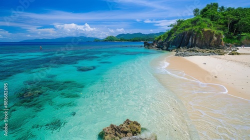 Experience the pristine beauty of Saud Beach in Pagudpud, Philippines. This captivating photo showcases its powdery white sand and crystal-clear turquoise waters. 