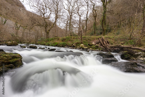 The East Lyn river flowing through the woods at  Watersmeet in Exmoor National Park photo