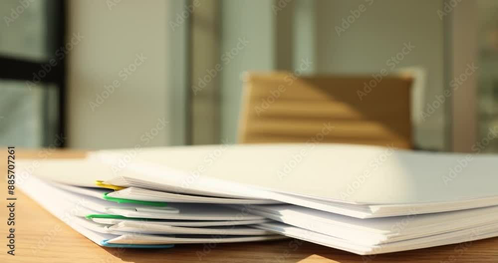 Taking papers connected with paperclips from high pile on table time lapse. Documents and reports in company office. Paperwork organization strategy Taking papers connected with paperclips from high pile on table time lapse. Documents and reports in company office. Paperwork organization strategy