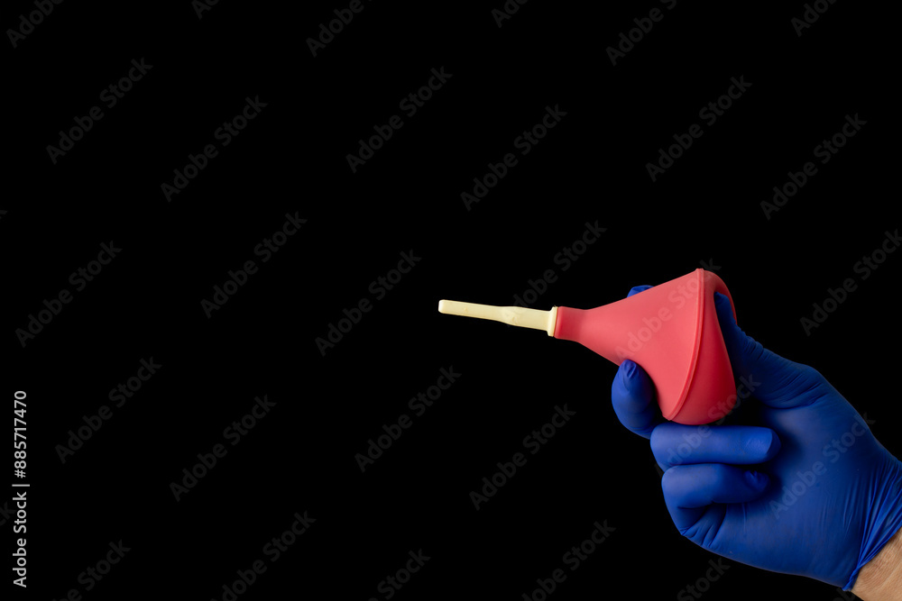 Enema in hand isolated on black background. Enema in hand isolated on black background.