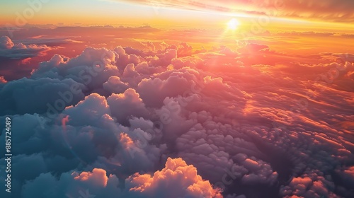 A view from an airplane window showing a sunrise over the clouds, creating a peaceful and inspiring backdrop © Dina