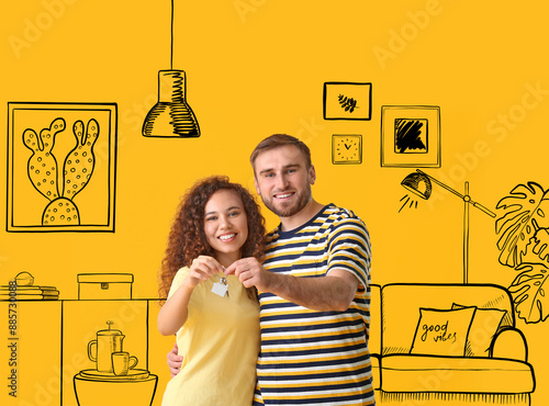 Happy young couple with key...