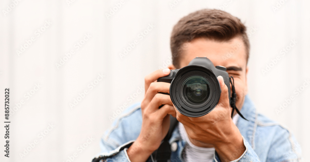 Young male photographer with camera outdoors Young male photographer with camera outdoors