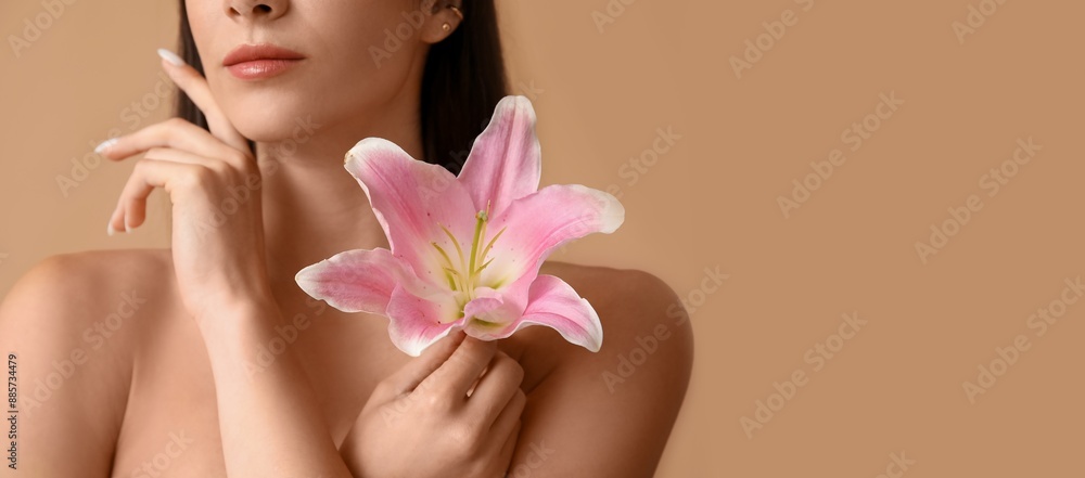 Beautiful young woman with pink lily flower on beige background with space for text, closeup Beautiful young woman with pink lily flower on beige background with space for text, closeup