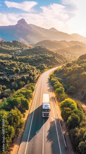 Scenic Highway Cargo Delivery with Truck Driving Through Mountain Landscape at Sunrise
