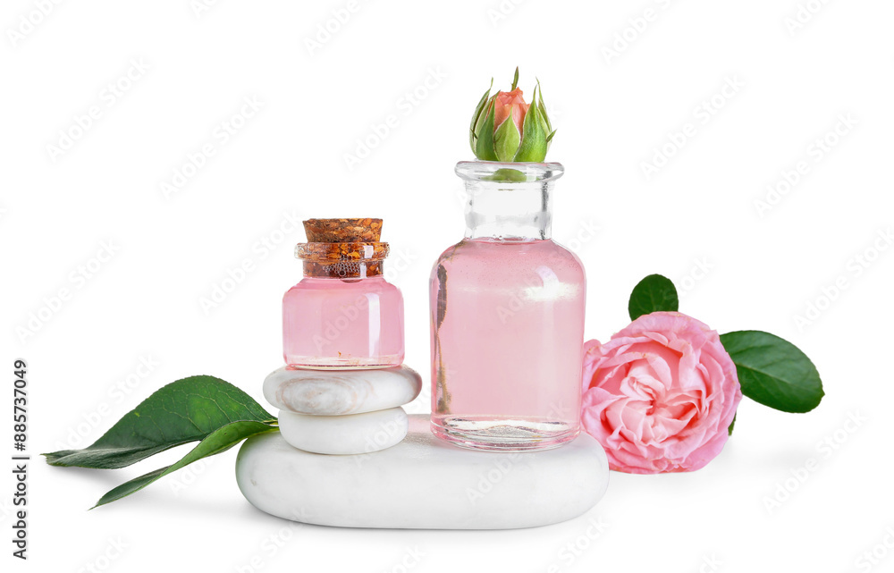 Bottles of cosmetic oil with rose extract and flowers on white background Bottles of cosmetic oil with rose extract and flowers on white background