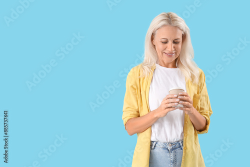 Mature woman with cup of co...