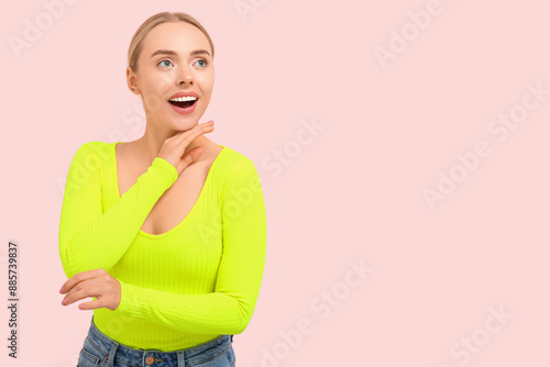 Pretty young woman on pink ...