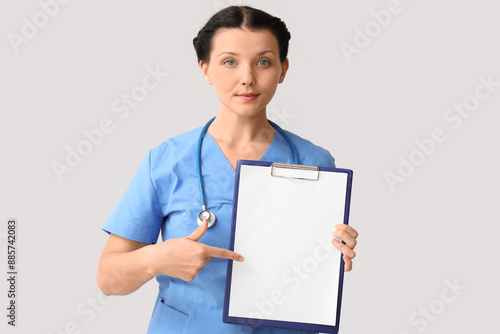 Female doctor pointing at c...