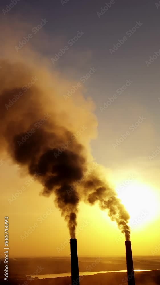 Smoking pipes of factory. Industrial chimneys with heavy smoke causing air pollution problem Vertical video Smoking pipes of factory. Industrial chimneys with heavy smoke causing air pollution problem Vertical video
