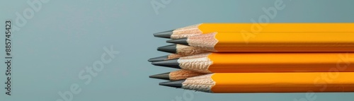 Row of yellow pencils on blue background photo