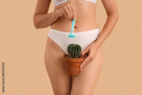 Fotografía Beautiful young woman with razor and cactus on beige background, closeup