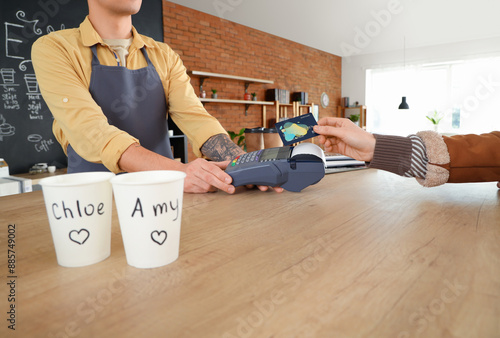 Male barista taking payment...