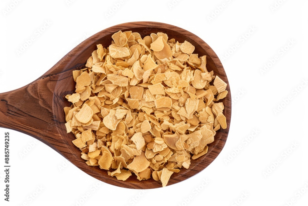 A wooden spoon filled with corn flakes for breakfast or snack A wooden spoon filled with corn flakes for breakfast or snack
