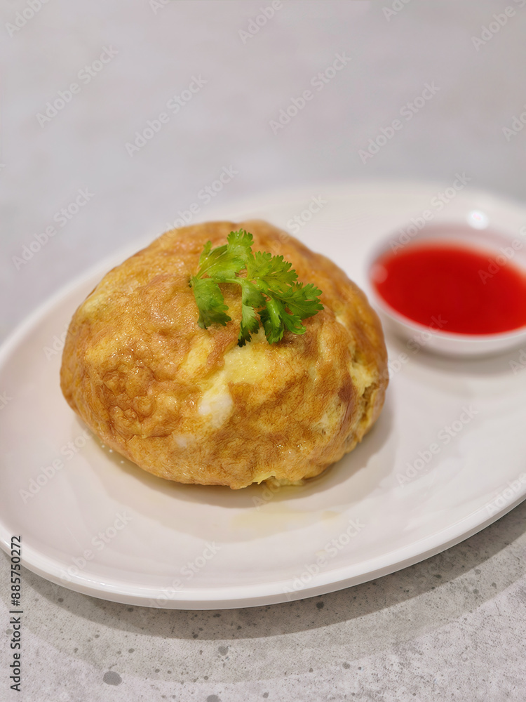 Crab omelet decorated with coriander leaves and chili sauce on white plate, Thai food. Crab omelet decorated with coriander leaves and chili sauce on white plate, Thai food.