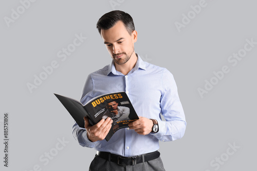 Handsome businessman readin...