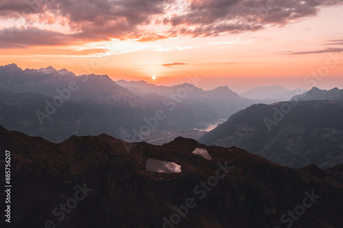 Sunset above mountain lakes and alpine peaks