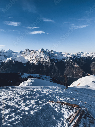 Mountaineer on top of a peak with a view