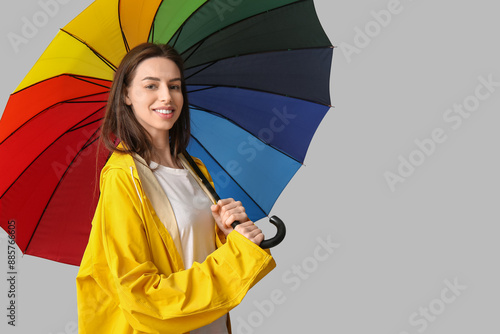 Young happy woman in rainco...