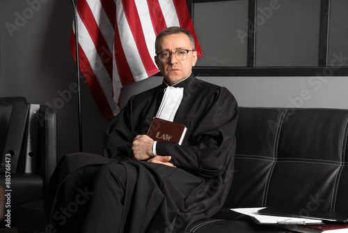 Mature judge with law book ...