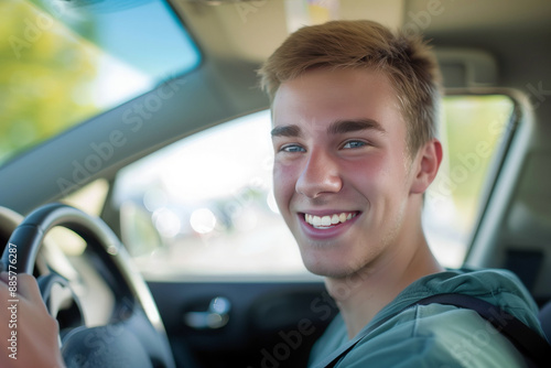 Portrait of a handsome young man driving a car, smiling © Виктория Марьенко