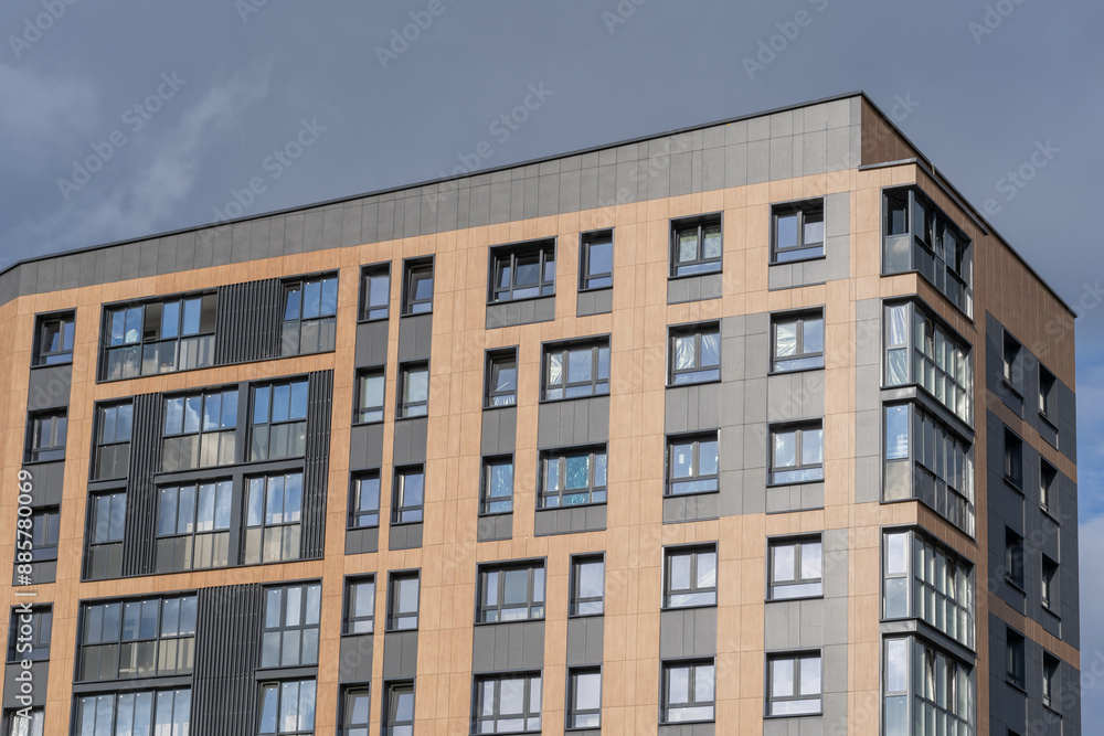 Modern brown building facade with shiny mirror windows against blue sky Modern brown building facade with shiny mirror windows against blue sky