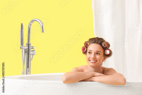 Young woman with hair curle...