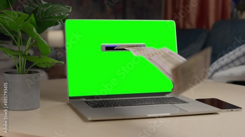 Money rain flying out of the laptop like ATM banking machine. Green screen. Make money online. Cash flow, dollar bills floating out of the laptop screen. Business making easy money online concept. 