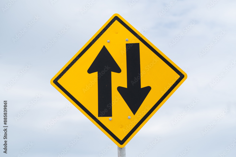 Two-way traffic ahead sign is on sky background. Two-way traffic ahead sign is on sky background.