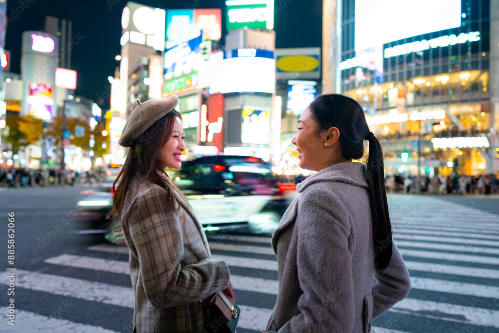 Asian woman shopping and walking city street crosswalk with crowd of people in Shibuya, Tokyo, Japan at night. Happy girl friends enjoy and fun outdoor lifestyle travel in the city on holiday vacation Asian woman shopping and walking city street crosswalk with crowd of people in Shibuya, Tokyo, Japan at night. Happy girl friends enjoy and fun outdoor lifestyle travel in the city on holiday vacation