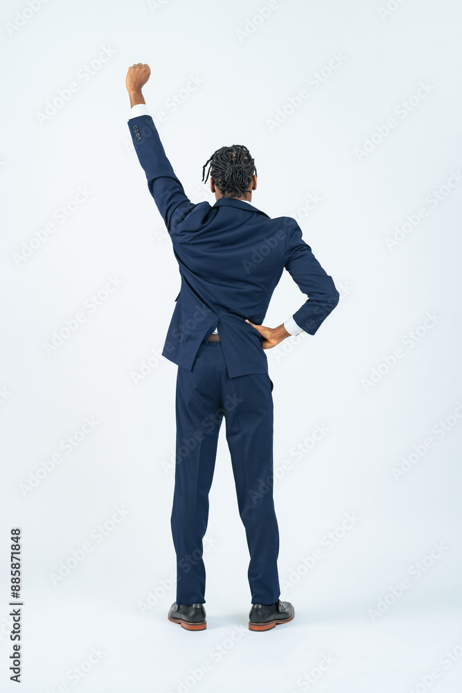 Full-body photo of a black male business person posing in a fist pump rear view
