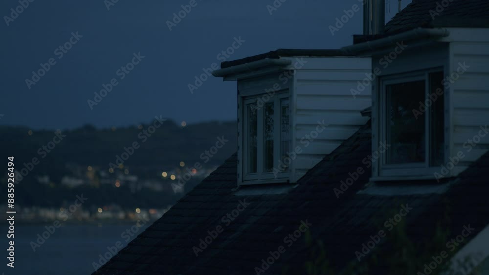House Roof Windows at Night with City Lights in the Background House Roof Windows at Night with City Lights in the Background