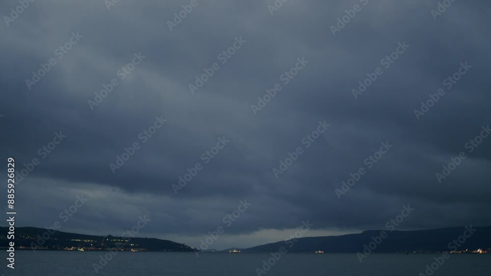 Evening to night timelapse with Storm Clouds above the bay Evening to night timelapse with Storm Clouds above the bay