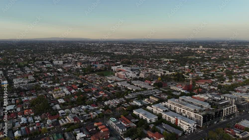 Aerial establishing shot of Suburb area of Melbourne City at sunset time. Residential complex and homes in Brunswick district, Australia. 
