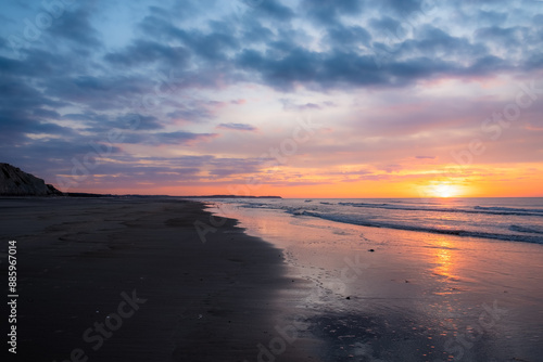 Wallpaper Mural Serene beach scene at sunrise, colorful sky, reflections on wet sand, peaceful and tranquil atmosphere Torontodigital.ca