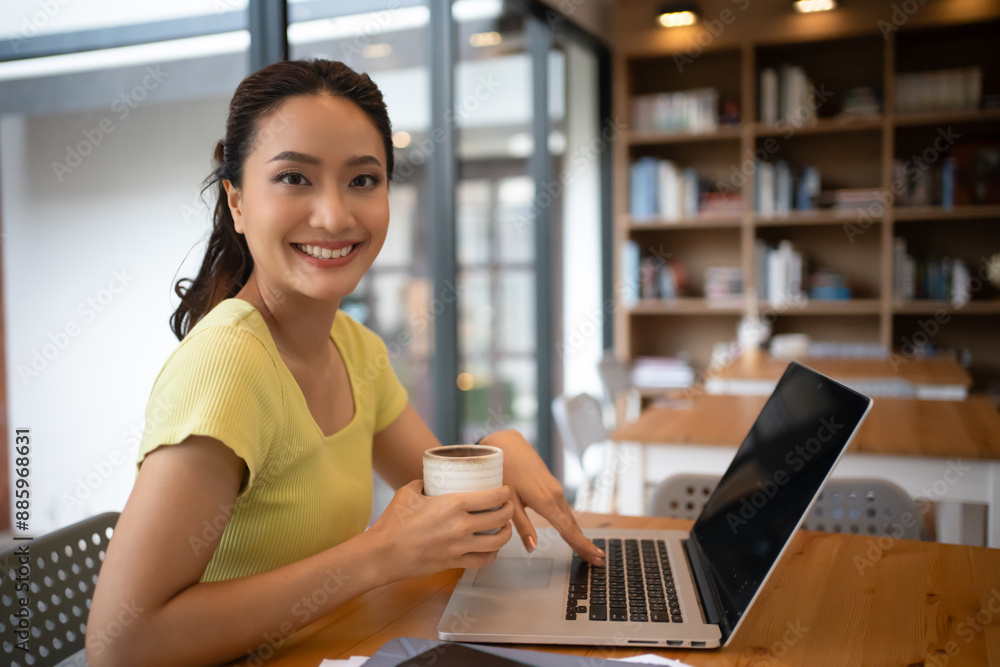 Fototapeta premium Woman sitting working with laptop at coffee shop, freelance woman working outside Concept.