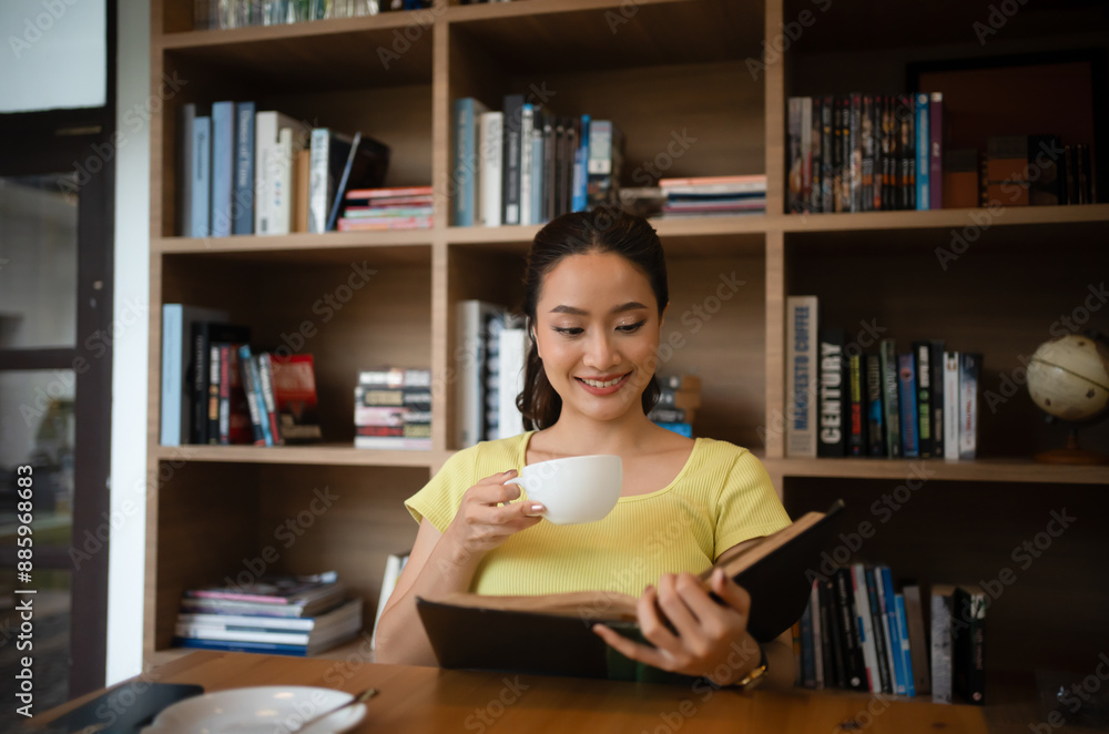 Young woman reading book and drink hot coffee in library at home, smiling, laughing, enjoying bookworms hobby, home leisure time Young woman reading book and drink hot coffee in library at home, smiling, laughing, enjoying bookworms hobby, home leisure time