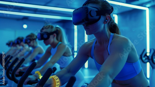 Girls are doing fitness on an exercise bike in the hall lit by neon lights in virtual glasses VR