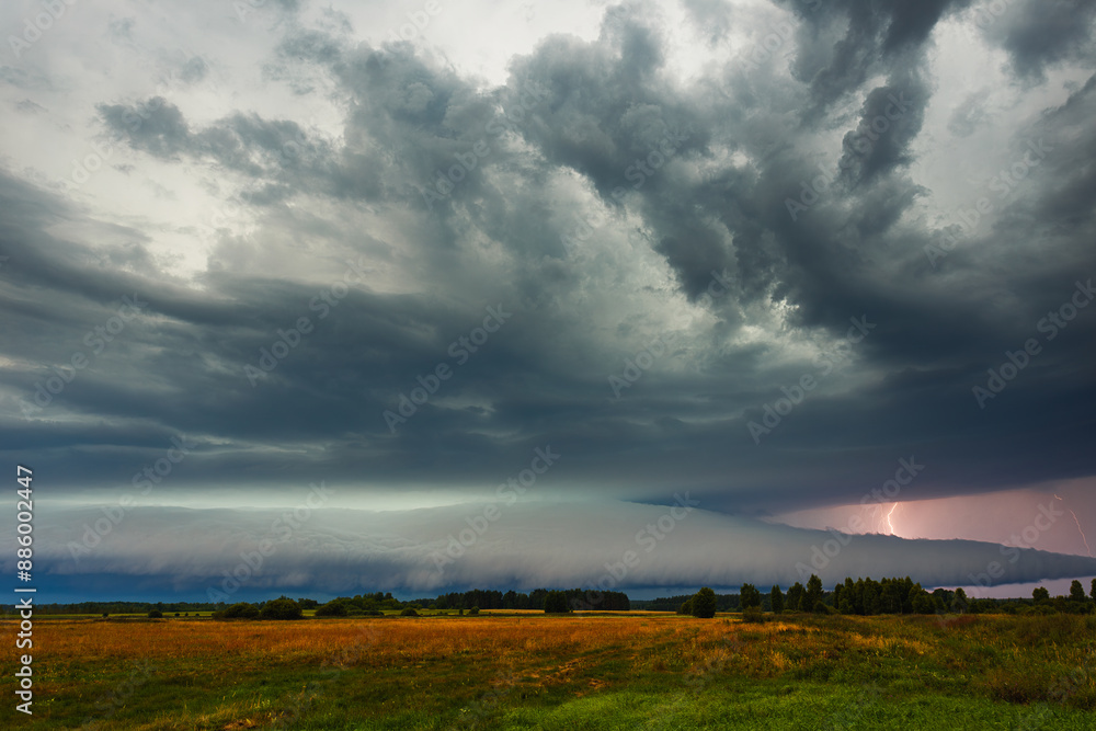 Supercell cloud with distant lightning illuminating the storm structure Supercell cloud with distant lightning illuminating the storm structure
