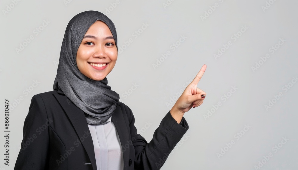 beautiful Smiling malay woman pointing finger right direction black suit, malaysia, white background beautiful Smiling malay woman pointing finger right direction black suit, malaysia, white background