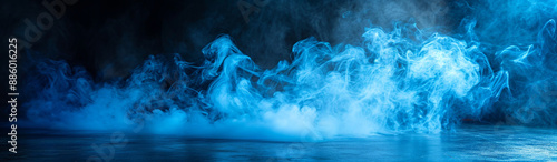 Ground magic blue smoke in dark room. Panoramic view of abstract fog.