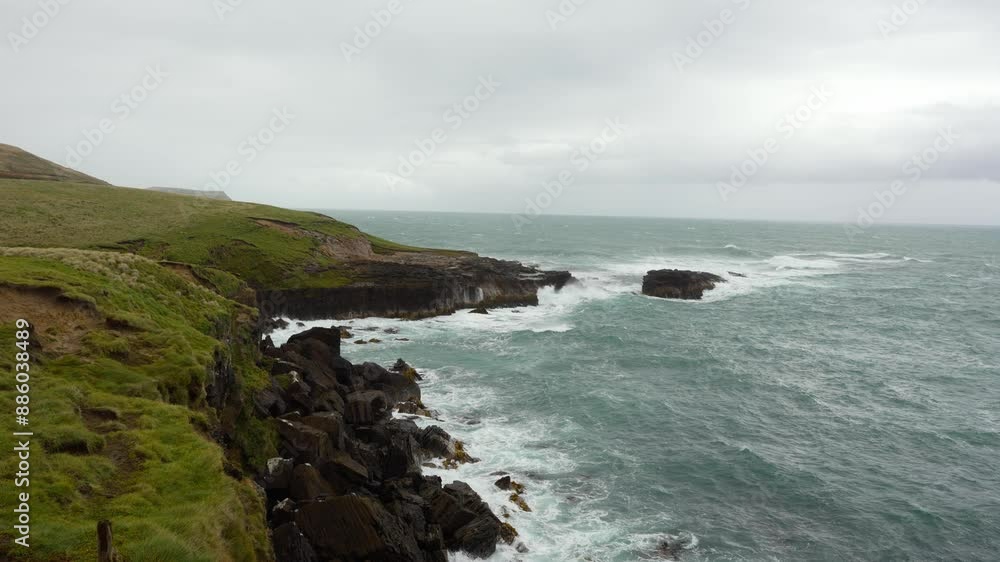 Rugged coastal cliffs and choppy waves at Slope Point in New Zealand's South Island Rugged coastal cliffs and choppy waves at Slope Point in New Zealand's South Island