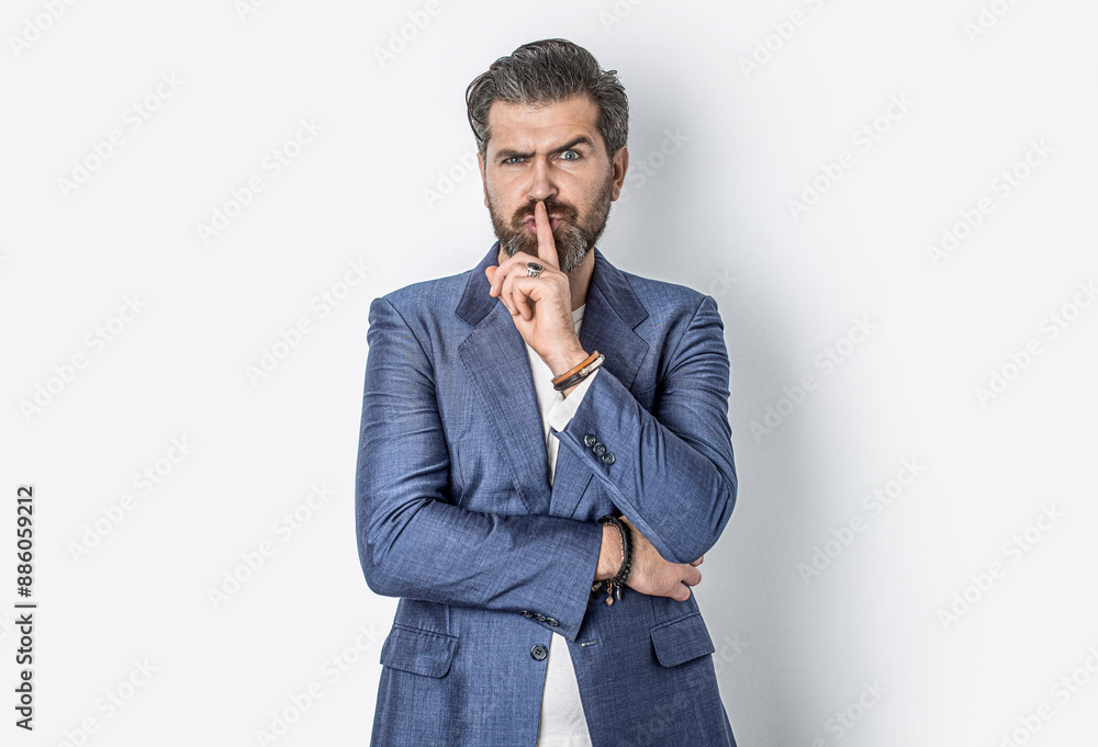 Secret and silence. Bearded man with shh gesture, asking for silence or to be quiet. Handsome man asking for silence, quiet, gesturing with finger in front of mouth, saying shh or keeping a secret Secret and silence. Bearded man with shh gesture, asking for silence or to be quiet. Handsome man asking for silence, quiet, gesturing with finger in front of mouth, saying shh or keeping a secret