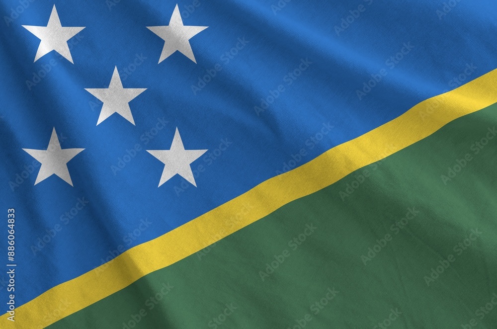 Solomon Islands flag depicted on folded wavy fabric of old cloth close up Solomon Islands flag depicted on folded wavy fabric of old cloth close up