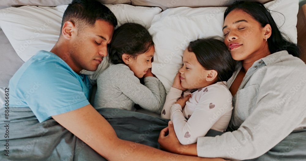 Fototapeta premium Rest, parents and children sleeping in bed for nap, dreaming or relax together in bedroom, Top view, family man and tired woman with girl kids in home for support, embrace or comfortable on weekend