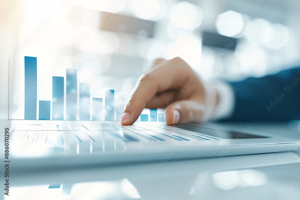 A detailed view of a financial advisor s hand tapping on a graph on a tablet, symbolizing financial planning, with ample copy space. A detailed view of a financial advisor s hand tapping on a graph on a tablet, symbolizing financial planning, with ample copy space.