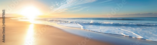 Breathtaking panoramic view of a serene beach at sunrise, with golden sands and gentle waves under a clear blue sky.