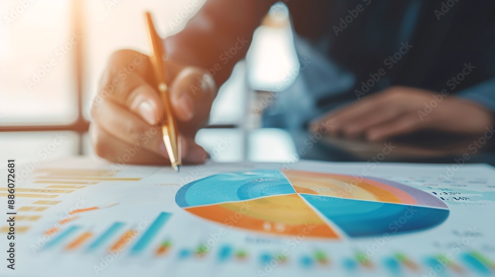Close-up of a financial advisor analyzing a pie chart with financial data, with ample copy space for additional content. Close-up of a financial advisor analyzing a pie chart with financial data, with ample copy space for additional content.